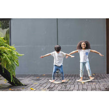 Load image into Gallery viewer, little kids balancing on eco-friendly wooden balance boards by plantoys