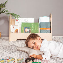 Load image into Gallery viewer, little boy in playroom in front of eco-friendly non-toxic wooden montessori book shelf by wood and hearts