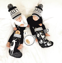 Load image into Gallery viewer, two baby boys checking organic cotton eco-friendly non-toxic christmas stockings in black and white neutral minimalist design by wee gallery