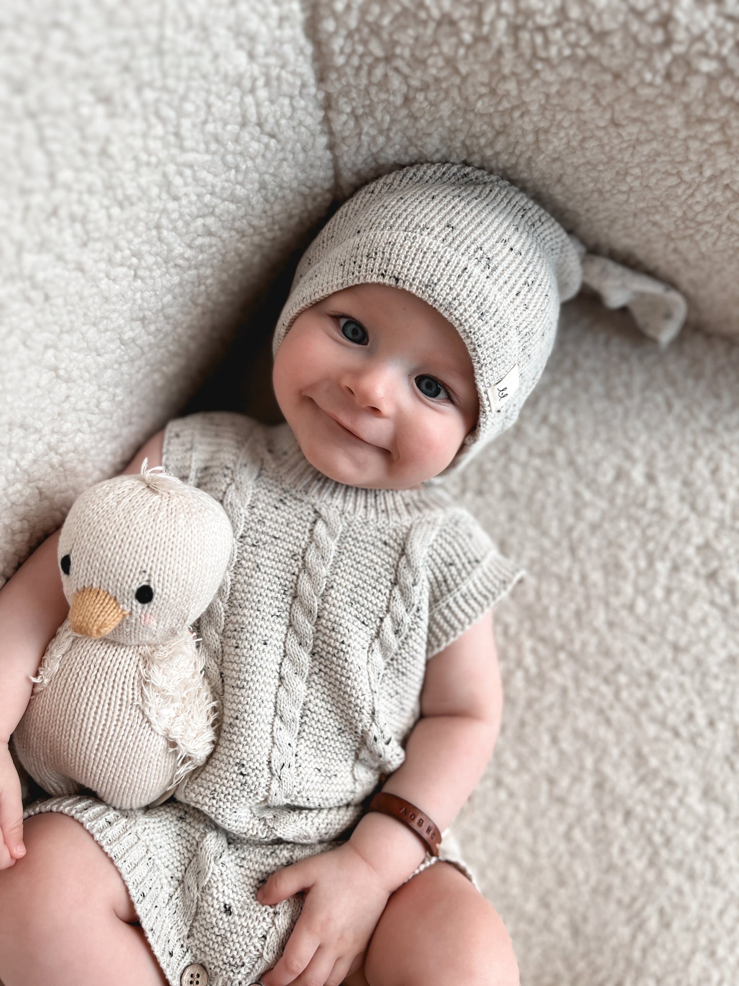 Smiling baby wearing organic cotton short-sleeve romper