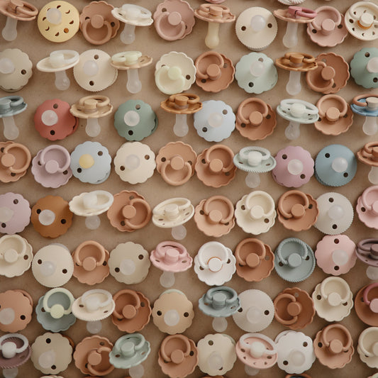 a bunch of non toxic pacifiers frigg