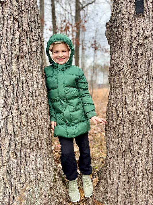 boy wearing green quince pfc pfas free eco-friendly warm winter jacket for kids 