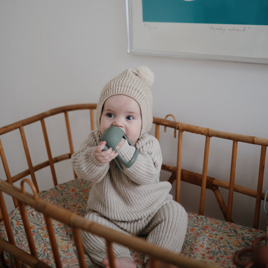 baby in bassinet with non-toxic silicone baby teether