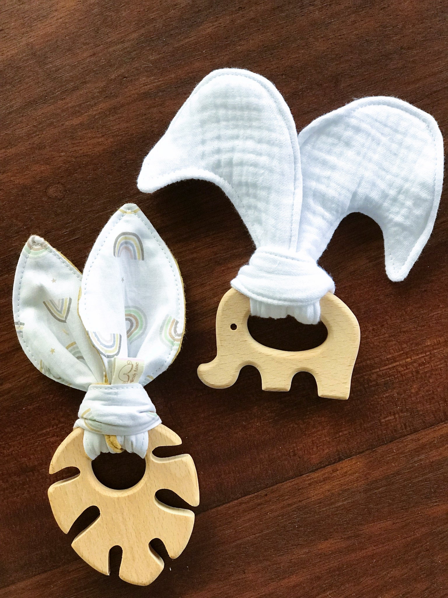 A natural maple wood teething ring with a soft, flower-patterned organic cotton tie from Wendy Anne.