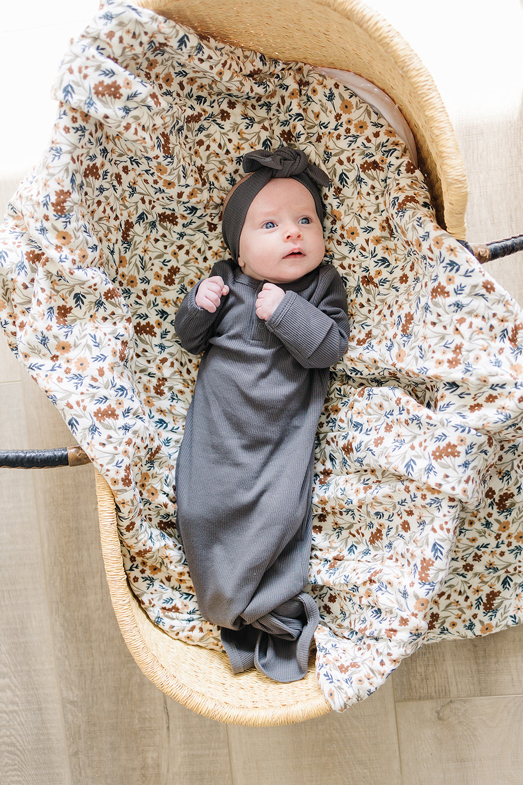 baby in bassinet wearing organic cotton non-toxic ribbed knot gown and headband