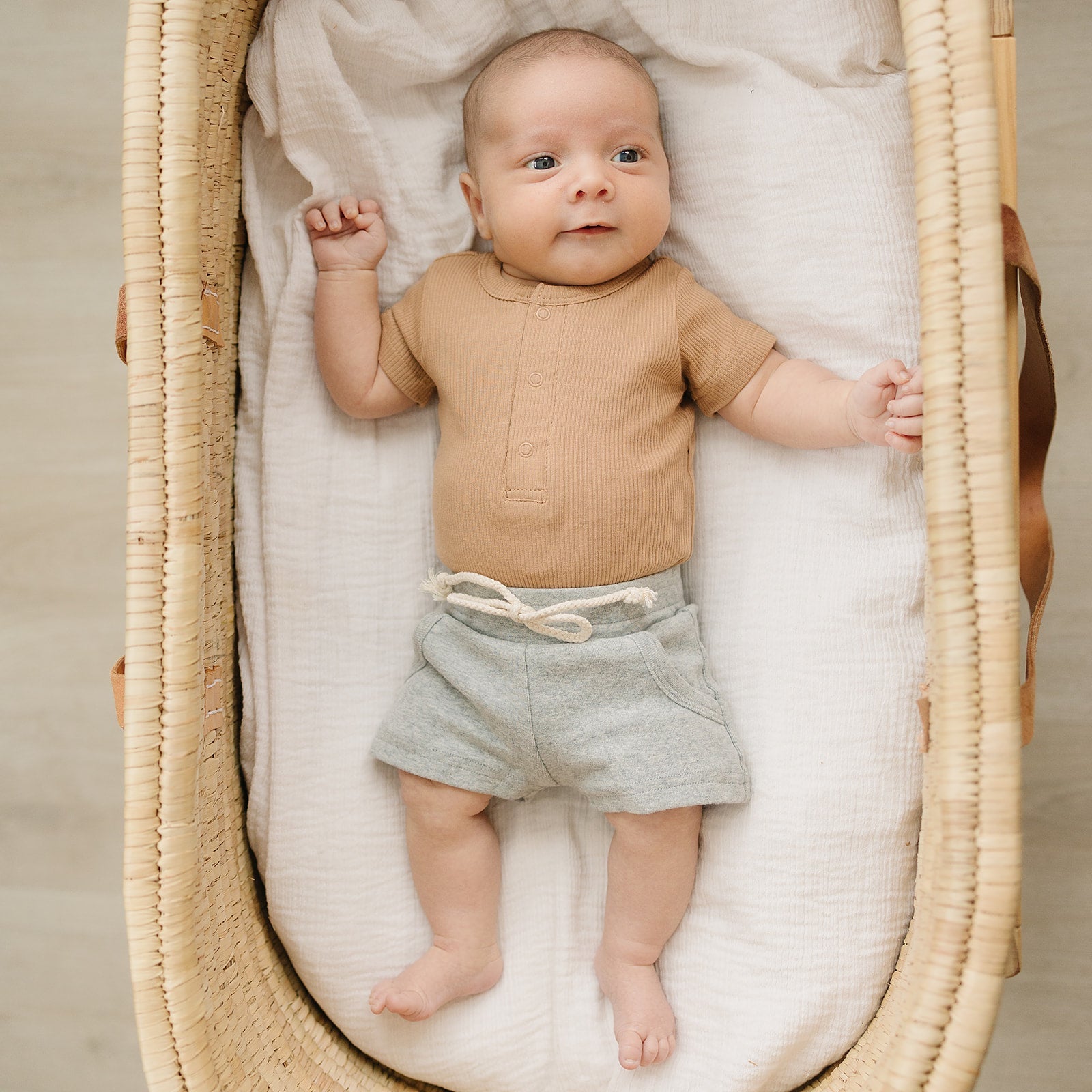 baby in bassinet wearing organic cotton non-toxic eco-friendly onesie bodysuit