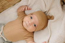 Load image into Gallery viewer, baby in bassinet wearing organic cotton knot hat and onesie mebie baby
