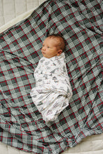 Load image into Gallery viewer, baby swaddled in sustainable stretch bamboo christmas tree swaddle by mebie baby
