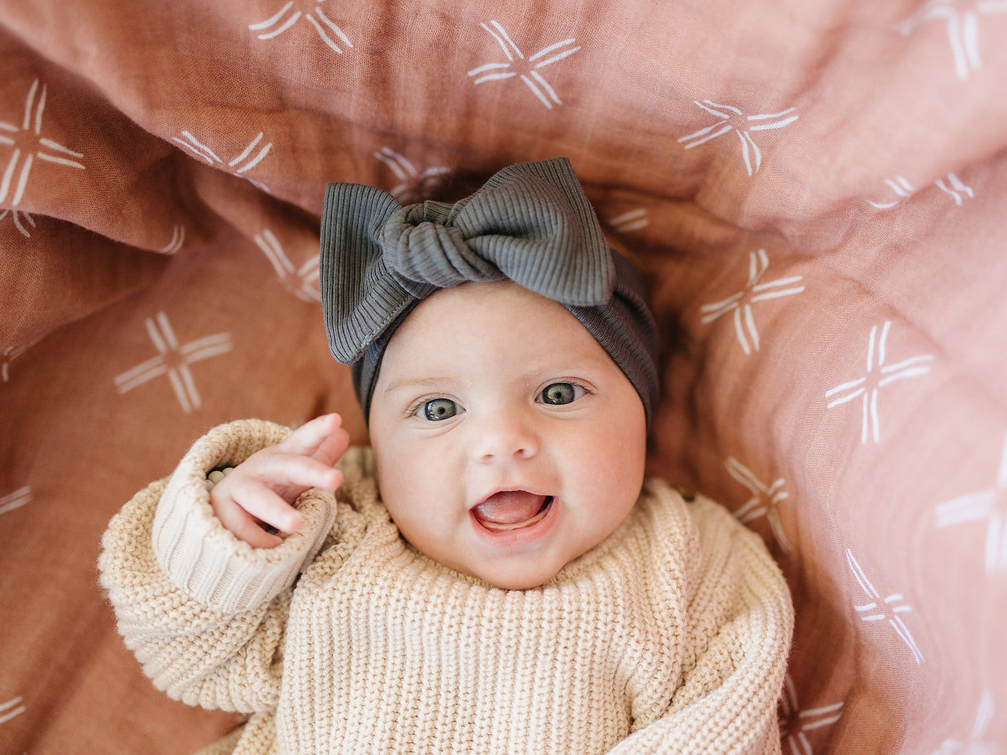 baby smiling wearing organic cotton head wrap bow mebie baby