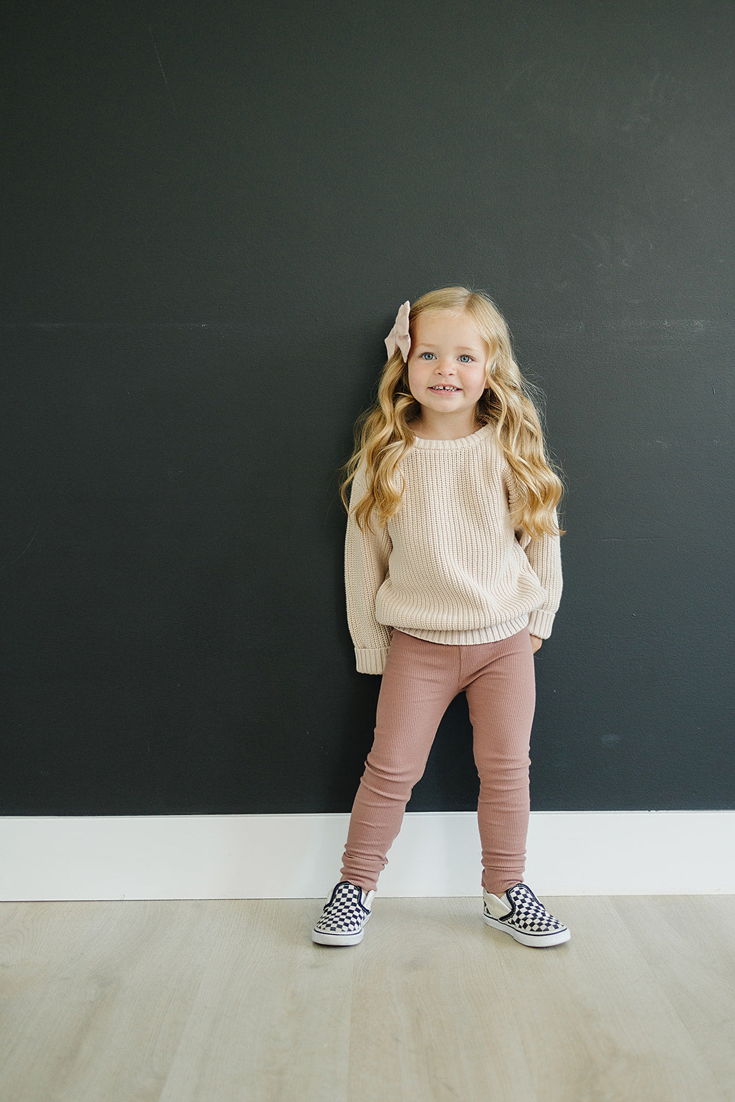 young girl smiling wearing organic cotton dusty rose color leggings by mebie baby