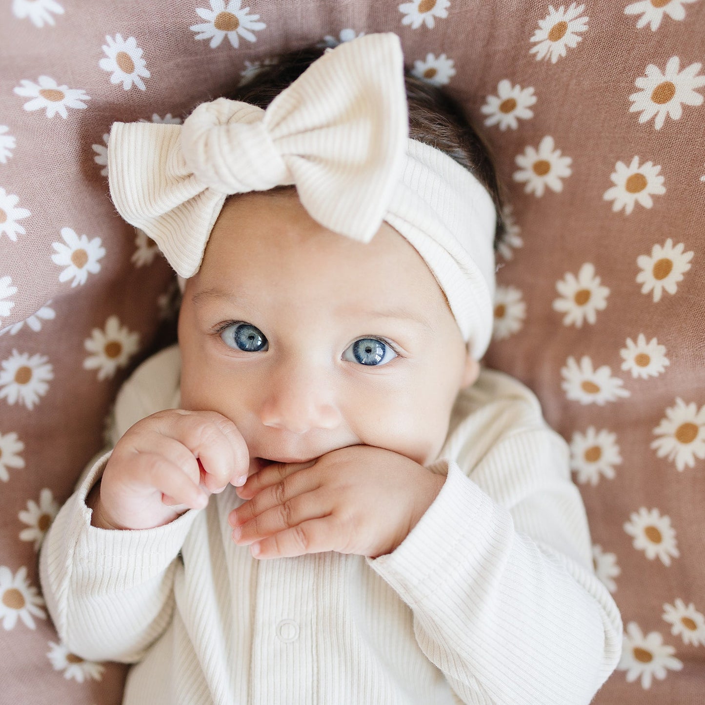 baby girl wearing organic cotton vanilla onesie and a matching bow head wrap mebie baby non-toxic eco-friendly