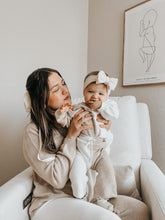 Load image into Gallery viewer, baby holding baby girl both in matching organic cotton knit color block beige and white lounge outfits
