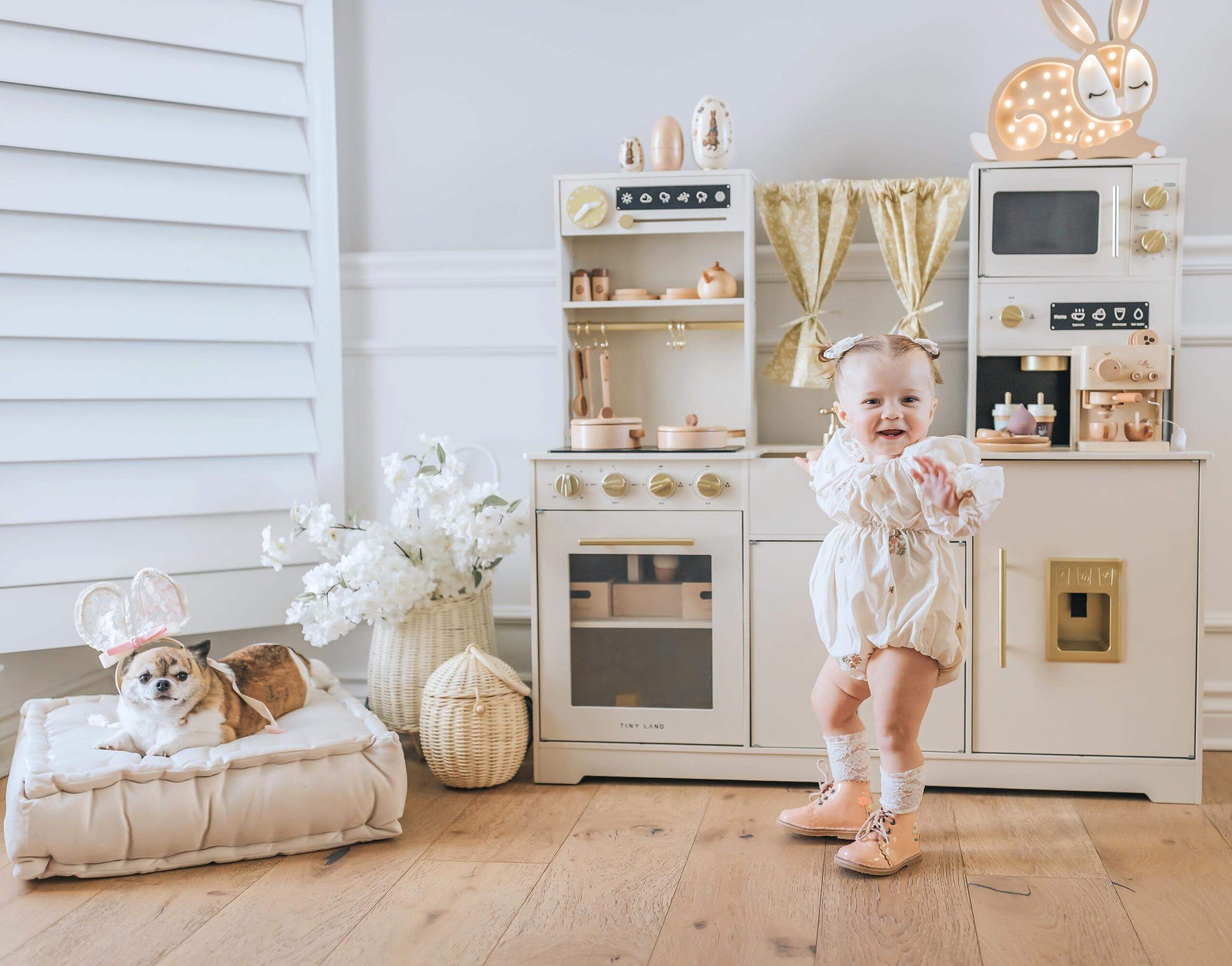 toddler girl smiling playing with eco-friendly play kitchen by tiny land