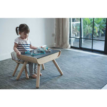 Load image into Gallery viewer, little girl sitting at the eco-friendly wooden kids&#39; table playing with lacing beads 
