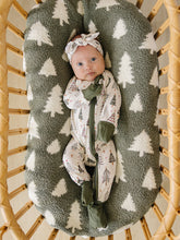 Load image into Gallery viewer, baby girl in bassinet wearing matching bamboo christmas tree onesie pajamas and a head wrap by mebie baby
