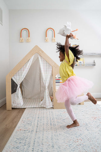 girl playing with a doll by wooden eco-friendly play house desk by avenlur