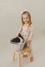 Load image into Gallery viewer, little girl smiling wearing sustainable bamboo pajamas lounge set with bunny design by mebie baby
