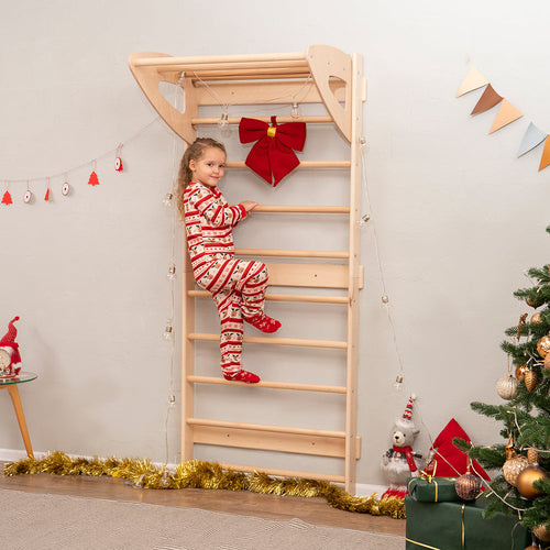 little girl climbing eco-friendly non-toxic wooden swedish wall ladder by wood and hearts