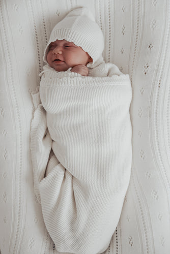 baby laying down wearing organic cotton non-toxic eco-friendly white knit bring me home newborn outfit kimono pants Bonnette blanket