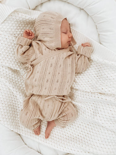 baby sleeping wearing organic cotton knit bring me home outfit by luca luna non-toxic eco-friendly