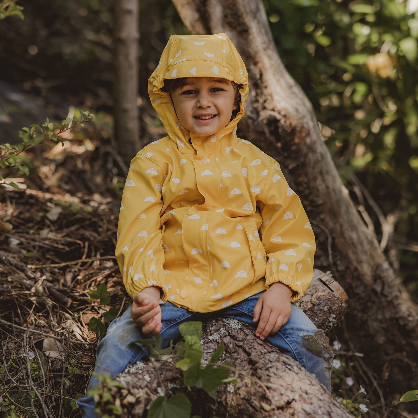 little boy wearing a non-toxic eco-friendly yellow raincoat by snapper rock