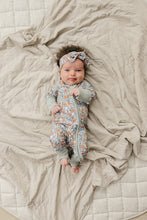 Load image into Gallery viewer, baby wearing sustainable bamboo dainty meadow zipper onesie pajamas and bow head wrap by mebie baby
