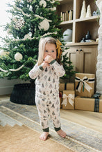 Load image into Gallery viewer, toddler girl wearing christmas tree sustainable bamboo pajamas by mebie baby in front of a christmas tree 
