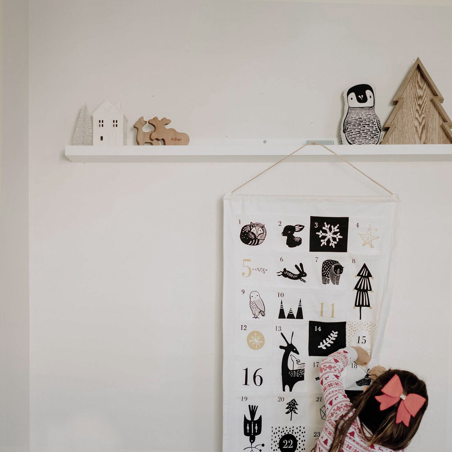 organic cotton neutral nature inspired advent calendar child checking a pocket