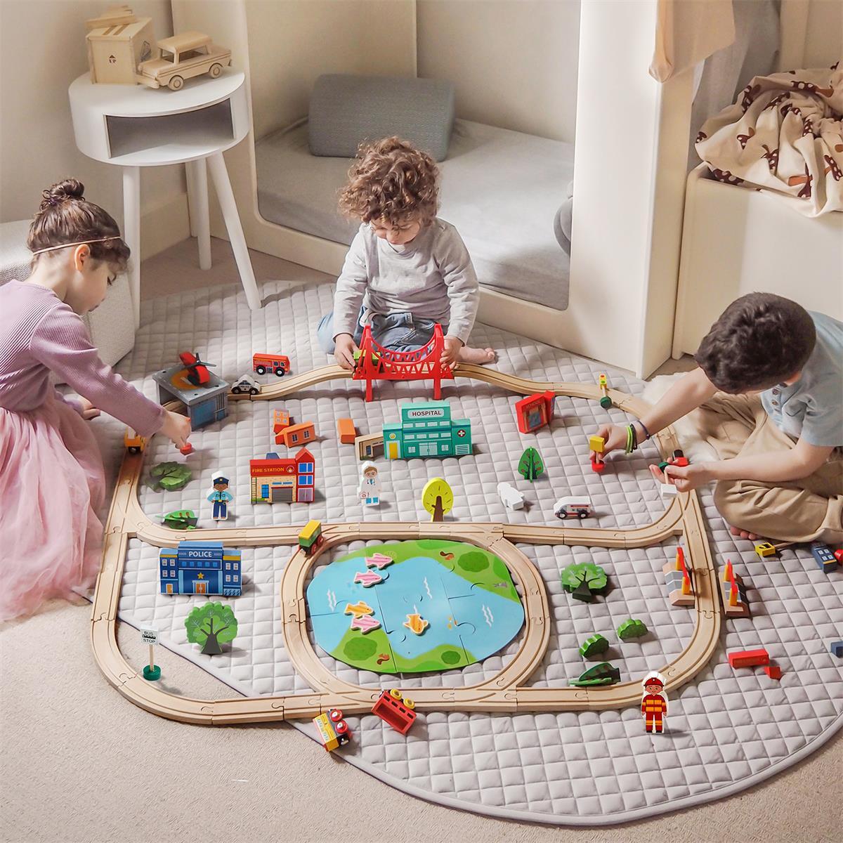 3 kids playing with 110 piece wooden eco-friendly train set by tiny land