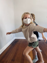 Load image into Gallery viewer, Toddler girl wearing organic cotton polka dot gender-neutral face mask
